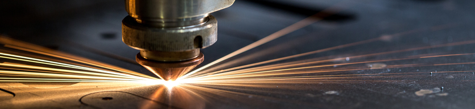 Cutting of metal. Sparks fly from laser, close-up